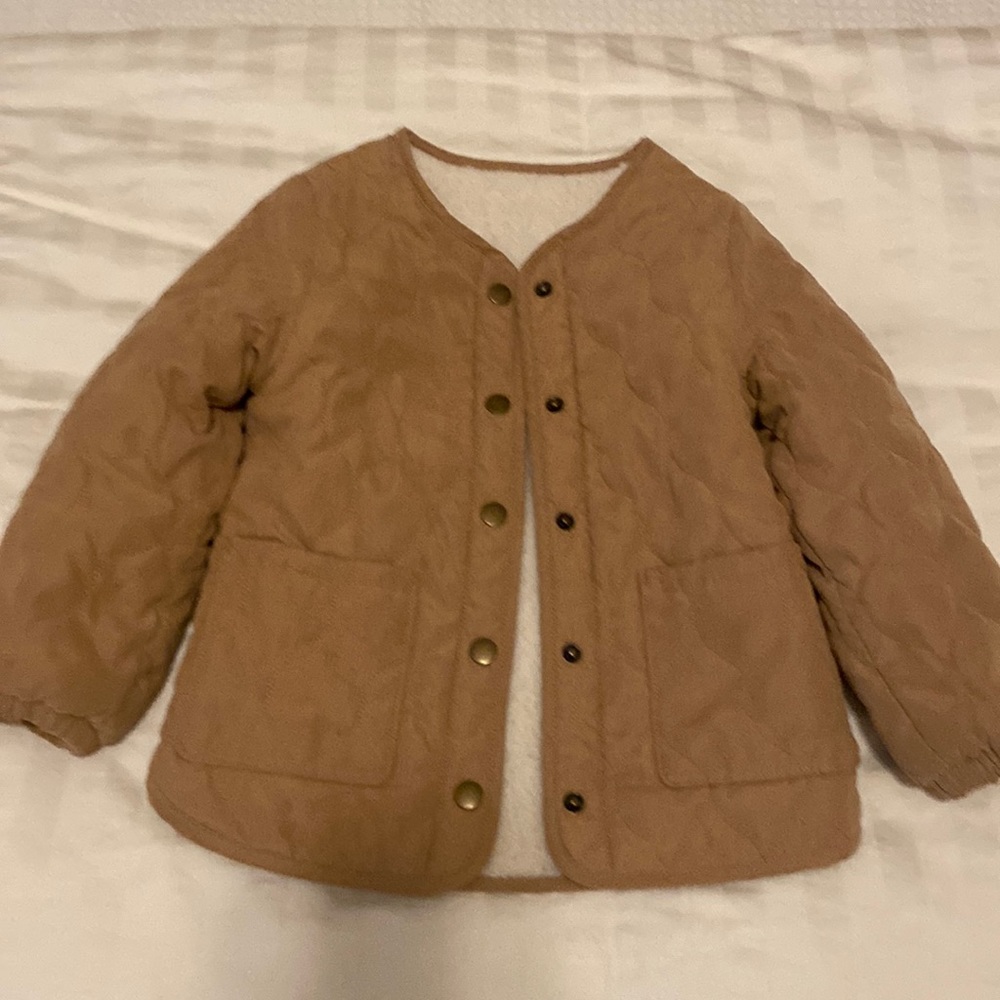 Heavy and warm quilted and Sherpa lined jacket in camel color.